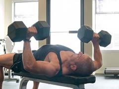 Donald Card lifting weights in the gym